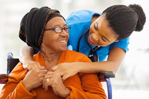 An elderly woman needing care, both smiling