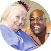 healthcare worker and elderly woman smiling
